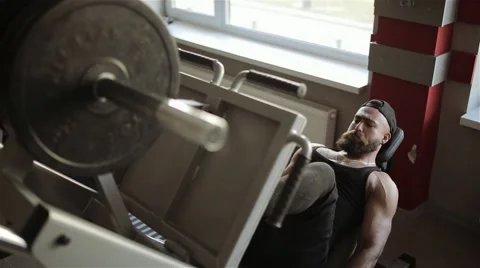 Man workout with simulator leg press in the gym Stock Footage 56635824