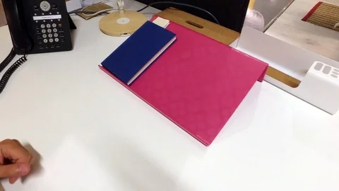 A man in the workplace is looking at a book. Stock Footage 79165149