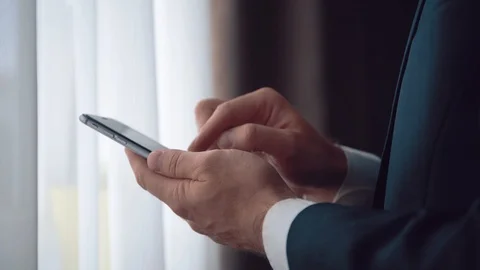 Man in the workplace using his smartphone, tapping on screen. Stock Footage 123916348