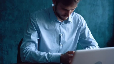 Man in the workplace using his smartphone, scrolling news Stock Footage 123916378