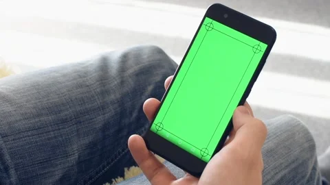 Man in the workplace using his smartphone with green screen. Hands top view. Stock Footage 139302136