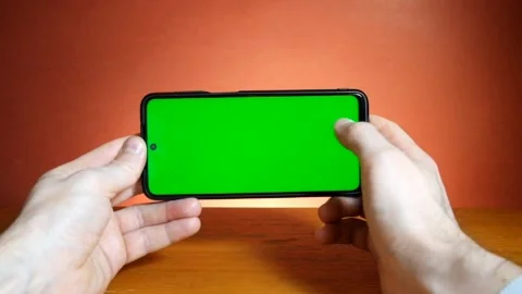 Man in the workplace using his smartphone with green screen. Stock-Footage 147656726