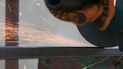 Man works angle grinder. Sparks fly from hot metal. Stock Footage 154556161