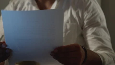 Man Works Back Late in Dark Office at Night, Looks Through Papers and Documents Stock Footage 108892849