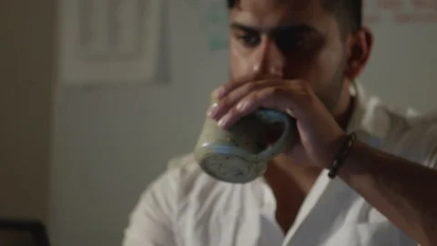 Man Works Back Late in Dark Office at Night, Types on Computer and Drinks Coffee Stock Footage 108892937