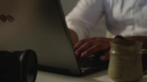 Man Works Back Late in Dark Office at Night, Types on Computer, Pan to Keyboard Stock Footage 108893056