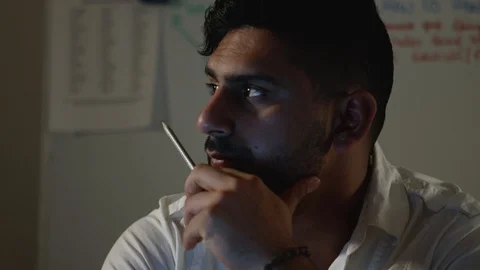 Man Works Back Late in Dark Office at Night, Strokes Face While Thinking Stock Footage 108893189