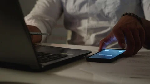 Man Works Back Late in Dark Office at Night, Answers Phone Call and Talks Stock Footage 108893317