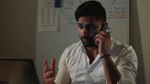 Man Works Back Late in Dark Office at Night, Talks on Phone with Boss or Client Stock Footage 108893478
