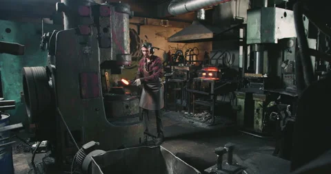 A man works as a blacksmith in a factory Stock-Footage 165217812