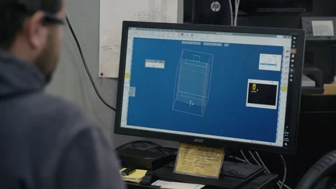 Man works on CAD machine creating components Stock Footage 103335796