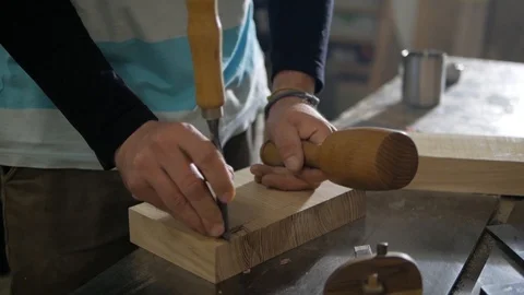 A man works a chisel and a mallet Stock Footage 99591829