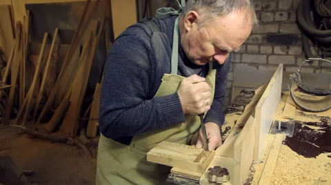 A man works a chisel with a tree Stock Footage 59696289
