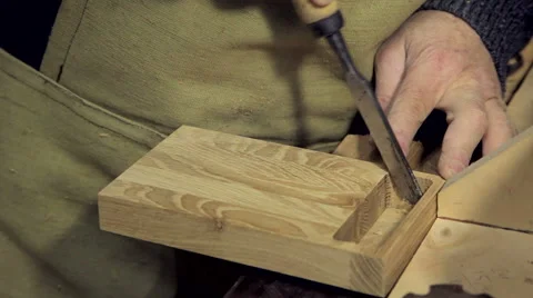 A man works a chisel with a tree Stock Footage 59696815