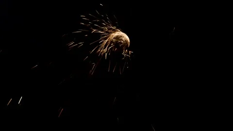 Man works circular saw over the steel. Sparks fly from hot metal on black Stock Footage