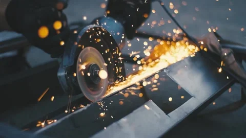 Man works circular saw. Sparks fly from hot metal. Man hard worked over steel Stock Footage