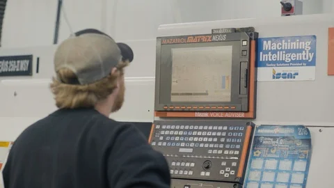 Man works on CNC machine creating components Stock-Footage 103335627