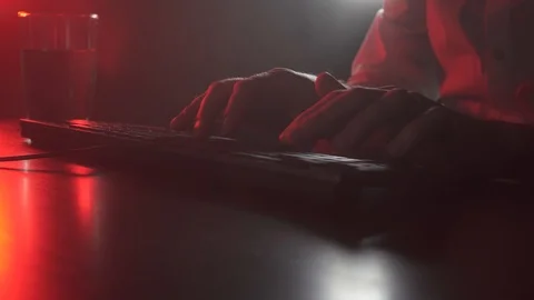 A man works at a computer and drinks water Stock Footage 118935915