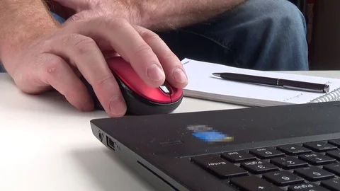 A man works on a computer and makes notes in a notebook - hands close up Video stock 76274907