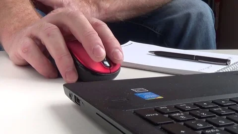 A man works on a computer and makes notes in a notebook - hands close up Stock Footage 76274917