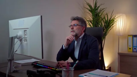 A man works on a computer and thinks about what he has done Stock-Footage 268328003