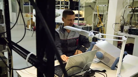 A man works on a computer creating projects for dental prosthetics. Worker in Stock Footage 95393491