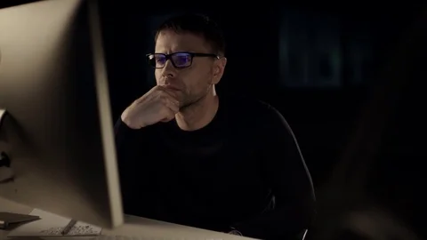 	The man works on the computer. The dark studio. Designer. Constructor. Architec Video stock 77676971