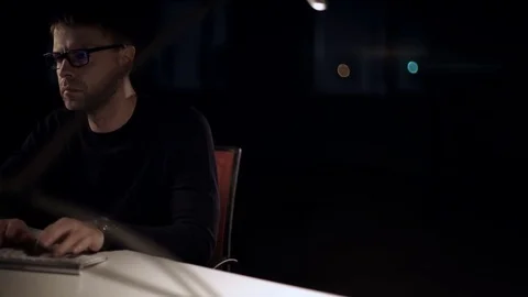 The man works on the computer. The dark studio. Designer. Constructor. Architect Stock Footage 77677211