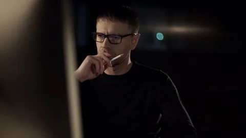 The man works on the computer. The dark studio. Designer. Constructor. Architect Stock Footage 77677279