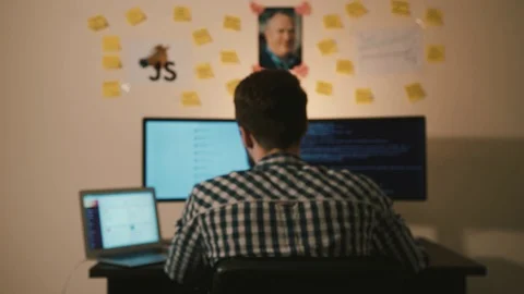 A man works at a computer 스톡 동영상 129455931