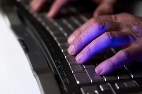 A man works at a computer. Hands of a man on the keyboard close-up. Programmer Stock Photos