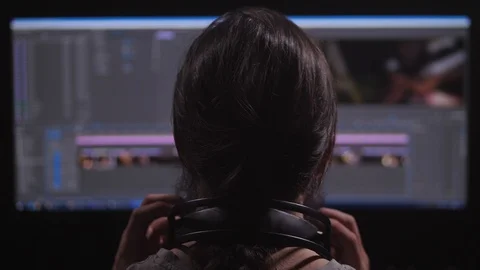 A man works at a computer. He has a video editor, he mounts video from different Stock Footage 105288202