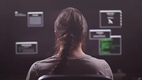 A man works at a computer. He is a programmer or hacker. On the monitor a lot of Stock Footage 105285590