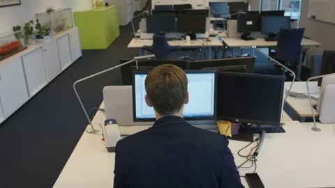Man works on the computer at his workplace Stock Footage 75491988