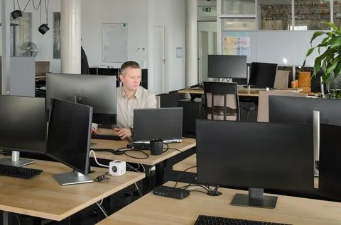 Man works at computer in an IT office Stock Photos