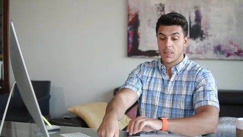 A man works at a computer at the office Stock Footage 100577022