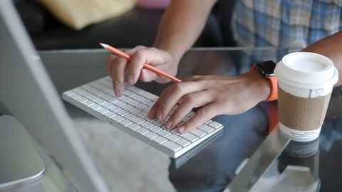 A man works at a computer at the office Stock Footage 100577250