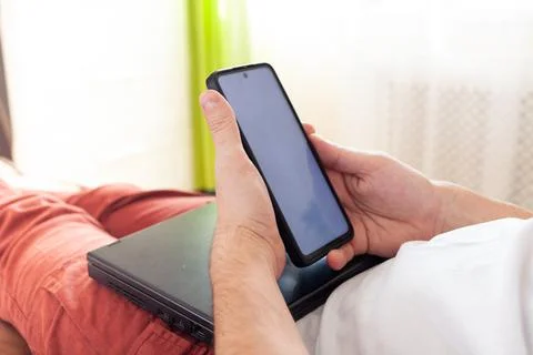 A man works on a computer remotely from home Stock Photos