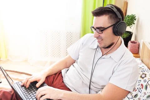 A man works on a computer remotely from home Stock Photos