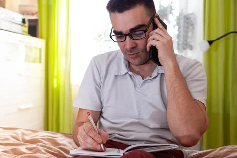 A man works on a computer remotely from home Stock Photos