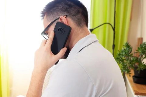 A man works on a computer remotely from home Stock Photos