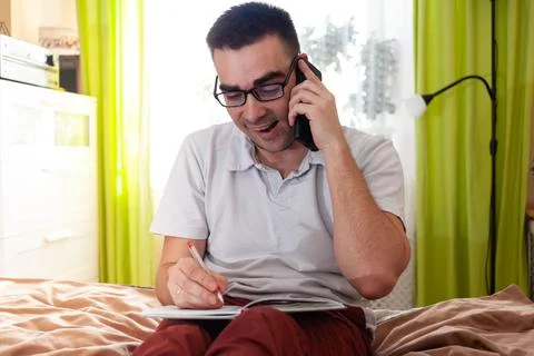 A man works on a computer remotely from home Stock Photos