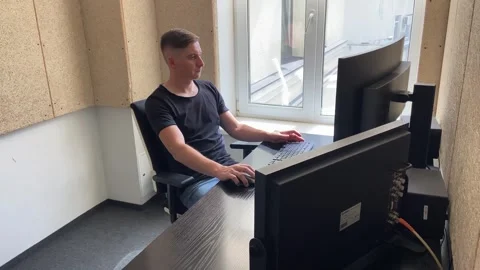 Man works at a computer types text on the keyboard and clicks the computer mouse Stock Footage 247020805