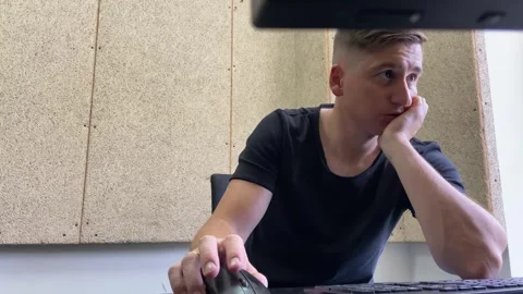 Man works at a computer types text on the keyboard and clicks the computer mouse Stock Footage 247145146