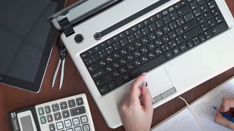 A man works on a computer. View from above. Types on a laptop keyboard, writes Stock Footage 132710638