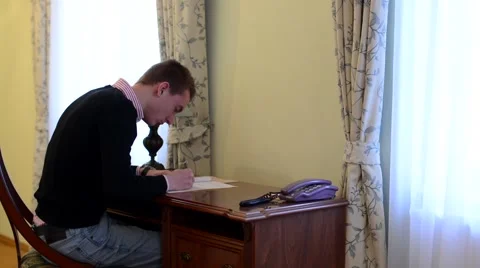 Man works at a desk - writing Stock Footage 47239476