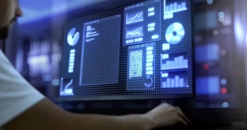 A man works on a desktop computer displaying line and pie charts, as well a.. Stock-Footage 246048528