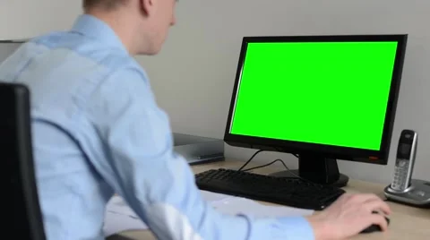 Man works on desktop computer in the office - use mouse - green screen  Stock Footage