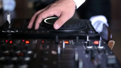 A man works with a DJ remote controler close up Stock Footage 80990112