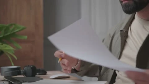 Man works with documents in neutral interior Stock Footage 137232556